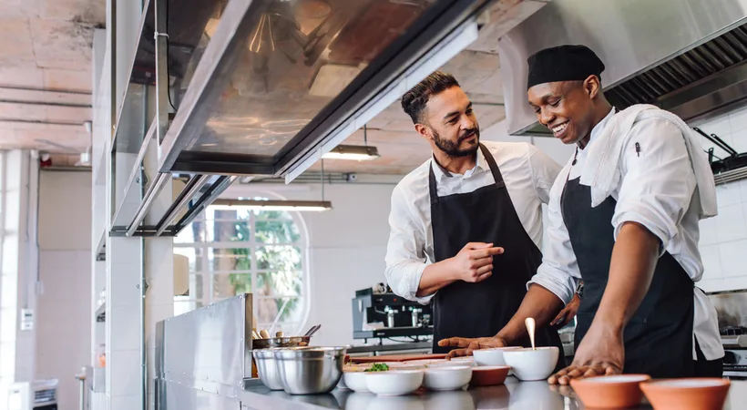 Two colleagues working together in a professional kitchen